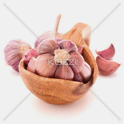 Garlic Cloves In Wooden Bowl Isolated On White Background